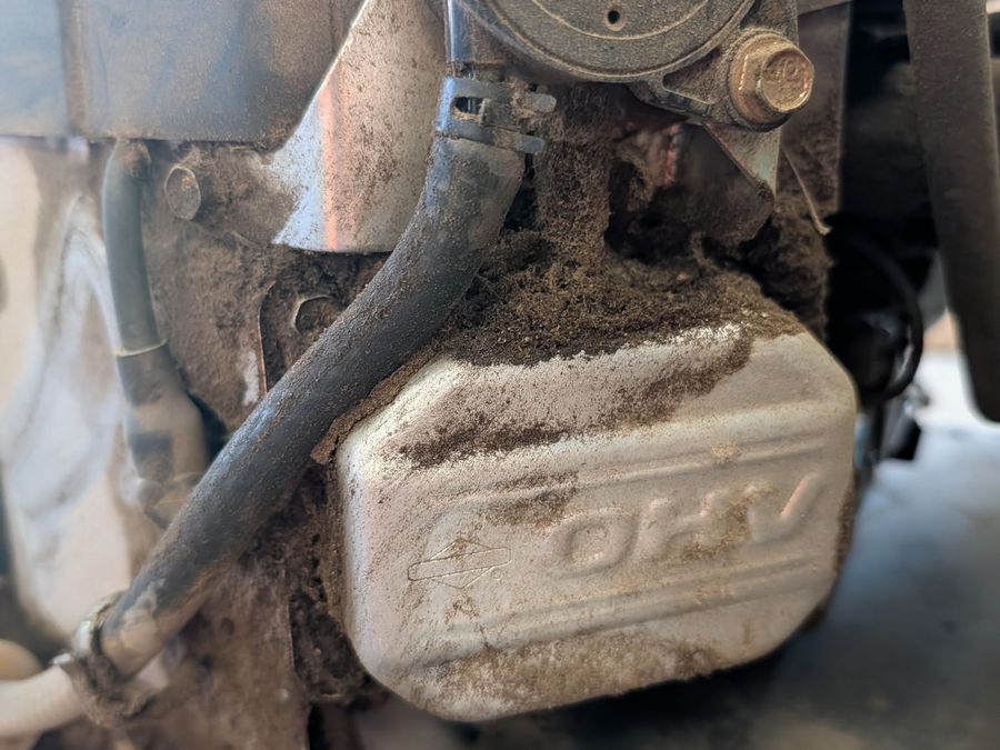 Engine packed with grass and debris before service